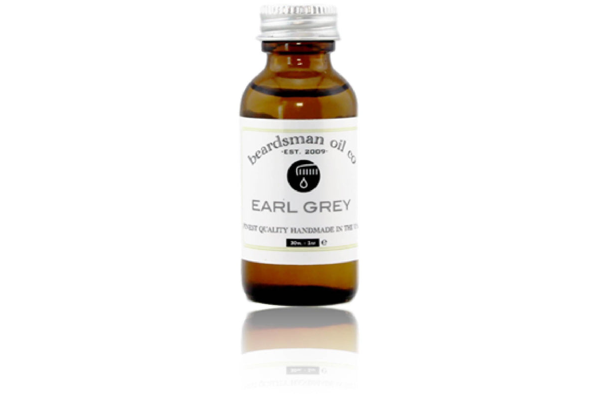 Amber glass bottle of Beardsman Oil Co Earl Grey beard oil, the brand’s flagship scent, with silver cap and white label.