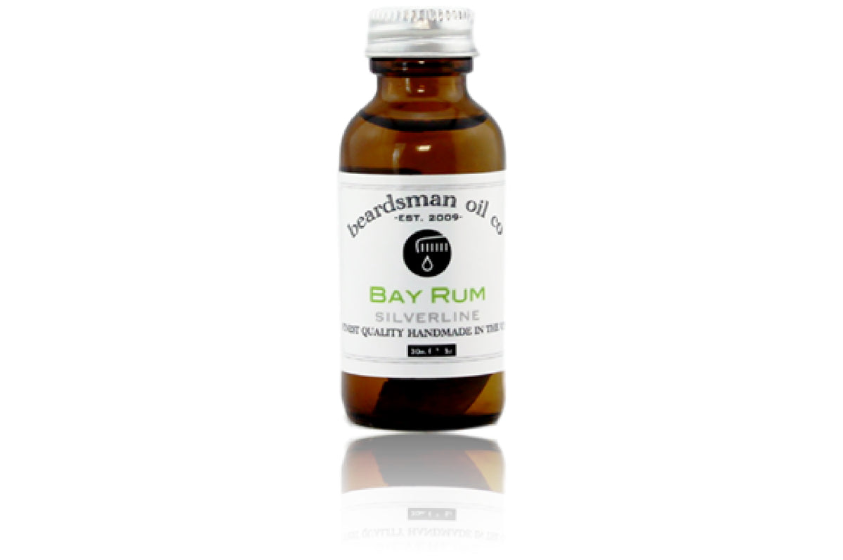 Amber glass bottle of Beardsman Oil Co Bay Rum beard oil with silver cap and white label.