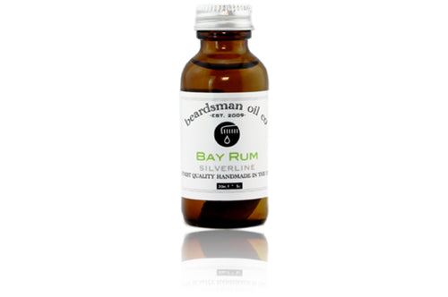 Amber glass bottle of Beardsman Oil Co Bay Rum beard oil with silver cap and white label.