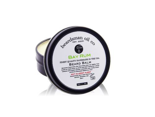 Open black tin of Beardsman Oil Co Bay Rum beard balm with white label, with reflection shown under
