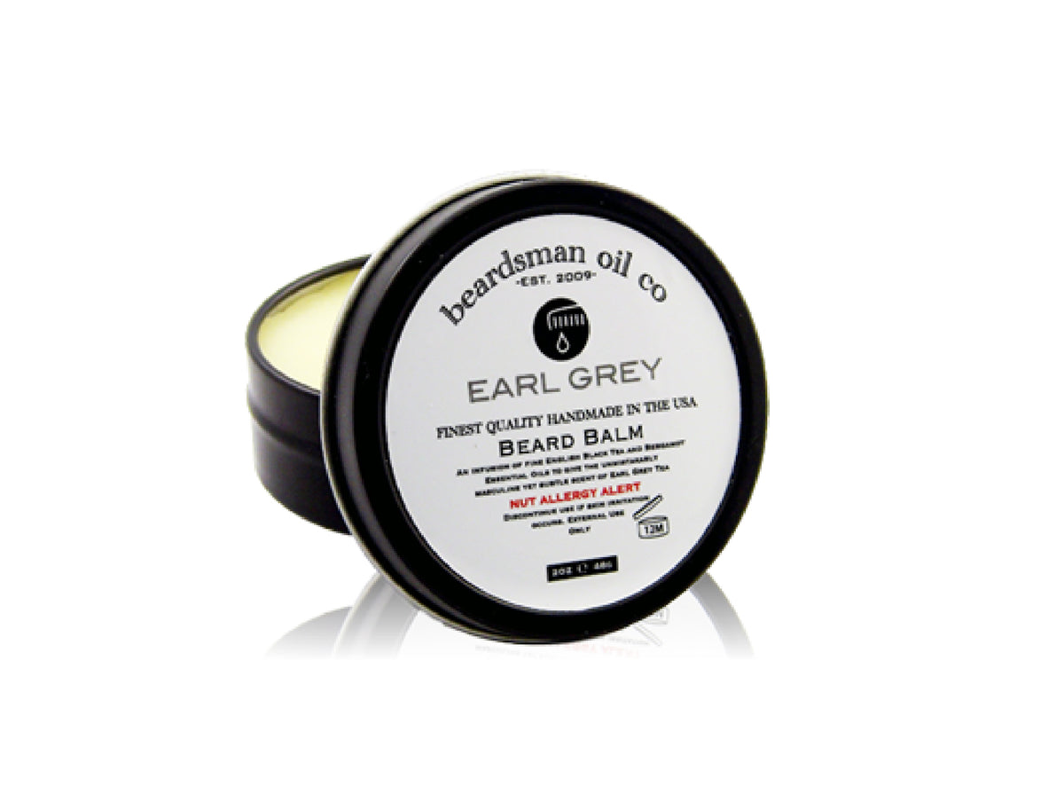 Open black tin of Beardsman Oil Co Earl Grey beard balm with white label
