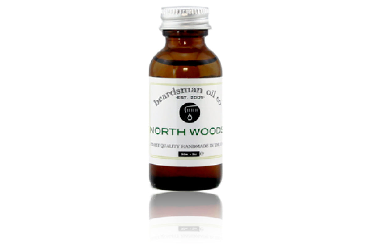 Amber glass bottle of Beardsman Oil Co North Woods beard oil with silver cap and white label.