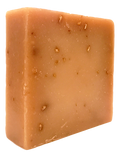 Cream-colored Oat, Milk & Honey cold-process soap bar with visible oat flecks and a lightly textured handmade surface, shown at an angle.