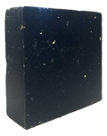 Opaque black Pine Tar cold-process soap bar with a slightly textured, handmade surface and squared edges, shown at an angle.