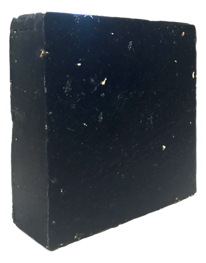 Opaque black Pine Tar cold-process soap bar with a slightly textured, handmade surface and squared edges, shown at an angle.
